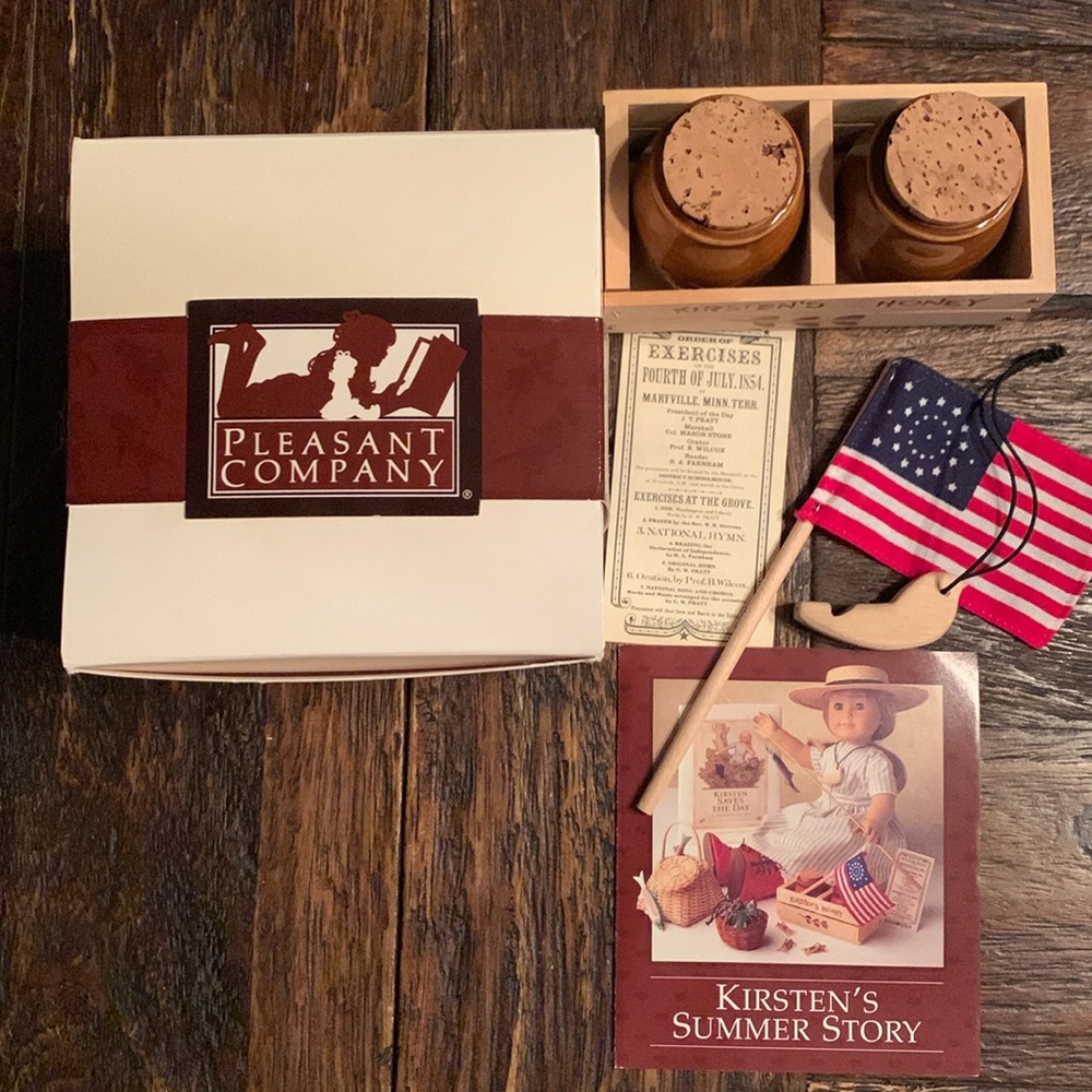 Honey pots in crate, bird whistle necklace, flag, 4 th of July ticket. Box